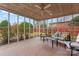 Relaxing screened-in porch with brick flooring, ceiling fan, and comfortable seating at 1511 35Th Ne Ave, Hickory, NC 28601