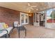 Relaxing screened-in porch with brick flooring, ceiling fan, and comfortable seating at 1511 35Th Ne Ave, Hickory, NC 28601