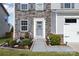 Inviting entryway with stone accents, manicured landscaping, and a charming 'Welcome' sign at 1535 Scarbrough Sw Cir, Concord, NC 28025