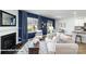 Open-concept living room with a cozy fireplace, ample seating, and a view into the dining area at 160 Falling Up Ln, Salisbury, NC 28147