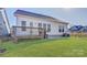 Backyard featuring a patio, wooden deck, and green lawn, perfect for relaxation and outdoor enjoyment at 19007 Dry Narrows Way, Charlotte, NC 28278