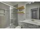 Modern bathroom with tiled shower, glass door, floating shelves, vanity, and decorative accents at 19007 Dry Narrows Way, Charlotte, NC 28278