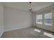 Bright bedroom featuring a stylish chandelier, plush carpeting and large windows, offering ample natural light at 19007 Dry Narrows Way, Charlotte, NC 28278