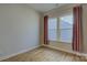 Cozy bedroom with natural light streaming through windows, complemented by stylish curtains and wood-look flooring at 19007 Dry Narrows Way, Charlotte, NC 28278