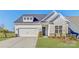Charming home with a white garage, stone accents, black front door, and a well-manicured lawn at 19007 Dry Narrows Way, Charlotte, NC 28278