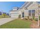 Charming home featuring a two-car garage, rock accents, and lush landscaping at 19007 Dry Narrows Way, Charlotte, NC 28278