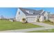 A lovely single-Gathering home boasts a well-maintained lawn and white garage, perfect for suburban living at 19007 Dry Narrows Way, Charlotte, NC 28278