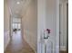Inviting hallway with white wainscoting and wood floors leading to the living area at 19007 Dry Narrows Way, Charlotte, NC 28278