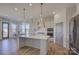 Bright kitchen featuring stainless steel appliances, an island, and modern pendant lights at 19007 Dry Narrows Way, Charlotte, NC 28278