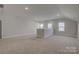 Spacious, naturally lit loft area with neutral carpeting, offering versatile living space and three bright windows at 19007 Dry Narrows Way, Charlotte, NC 28278