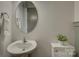 Charming powder room features a pedestal sink, stylish fixtures, and a decorative mirror at 19007 Dry Narrows Way, Charlotte, NC 28278