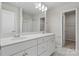 Bathroom featuring double sinks, modern lighting, and a shower/tub combo at 2132 Clapham Ct, Charlotte, NC 28215