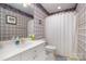 Bright bathroom with tiled walls, shower with curtain, and sink with vanity at 286 Canvasback Rd, Mooresville, NC 28117