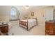 Bright bedroom with a window seat, ceiling fan, and neutral carpet at 286 Canvasback Rd, Mooresville, NC 28117