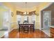 Bright dining area with bay windows, a chandelier, and hardwood floors at 286 Canvasback Rd, Mooresville, NC 28117