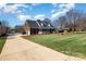 Beautiful brick home featuring a well-maintained lawn and a long driveway at 286 Canvasback Rd, Mooresville, NC 28117