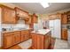 Kitchen featuring stainless steel appliances, wood cabinets, granite countertops, and hardwood floors at 286 Canvasback Rd, Mooresville, NC 28117