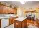 Spacious kitchen featuring an island with granite countertops, tile backsplash, and wood cabinetry at 286 Canvasback Rd, Mooresville, NC 28117