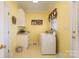 Bright laundry room features a washing machine, cabinets, sink, and yellow walls at 286 Canvasback Rd, Mooresville, NC 28117