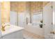 The main bathroom offers a soaking tub, white cabinets, and gold hardware at 286 Canvasback Rd, Mooresville, NC 28117