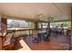 Covered outdoor patio featuring comfortable seating and a table for dining at 286 Canvasback Rd, Mooresville, NC 28117