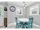 Charming dining area with a round table and stylish blue chairs, bathed in natural light from multiple windows at 302 Digh St, Gastonia, NC 28052