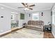 Open living room with hardwood floors, a leather sofa, and seamlessly connects to the dining area at 302 Digh St, Gastonia, NC 28052