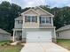 Two-story home featuring a two-car garage, stone accents, and multi-toned siding at 3270 Maple Ridge Dr, Gastonia, NC 28052