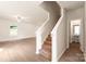 A staircase leads to the upstairs, adjacent to living area and half bath at 3270 Maple Ridge Dr, Gastonia, NC 28052