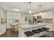 Bright kitchen features granite countertops, a stainless steel oven, an island with bar seating, and a breakfast nook at 3511 Erinbrook Ln, Charlotte, NC 28215