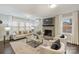 Cozy living room featuring a fireplace, plush seating, and ample natural light through large windows at 3511 Erinbrook Ln, Charlotte, NC 28215