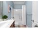 Bathroom with wood vanity, neutral walls, framed mirror, and a shower-tub combination at 4008 Saint Andrews Ct, Cramerton, NC 28032