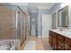Well-lit bathroom equipped with a glass shower, soaking tub, and vanity sink at 4008 Saint Andrews Ct, Cramerton, NC 28032