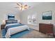 Bright bedroom features a ceiling fan, a large window with plantation shutters, and stylish decor at 4008 Saint Andrews Ct, Cramerton, NC 28032