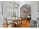 Charming breakfast nook features a round table, wood floors, and natural light at 4008 Saint Andrews Ct, Cramerton, NC 28032