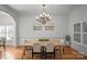 Dining room with hardwood floors, modern chandelier, and natural light from large shuttered windows at 4008 Saint Andrews Ct, Cramerton, NC 28032