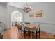 Elegant dining area with hardwood floors, chandelier, and open view to a connecting breakfast area at 4008 Saint Andrews Ct, Cramerton, NC 28032
