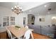Open-concept dining room boasts hardwood floors, modern chandelier, and stone fireplace accent at 4008 Saint Andrews Ct, Cramerton, NC 28032