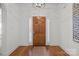 Bright entryway features a wooden front door, wood flooring, and a decorative light fixture at 4008 Saint Andrews Ct, Cramerton, NC 28032