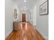Bright foyer with hardwood floors, neutral walls, front door view, decorative wall art and light fixture at 4008 Saint Andrews Ct, Cramerton, NC 28032