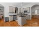Well-equipped kitchen with stainless steel appliances, island, and hardwood flooring at 4008 Saint Andrews Ct, Cramerton, NC 28032