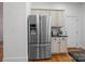 Stainless steel refrigerator complements the kitchen's cabinetry and granite countertops at 4008 Saint Andrews Ct, Cramerton, NC 28032
