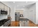 Well-lit kitchen featuring stainless steel appliances and a center island with black countertops at 4008 Saint Andrews Ct, Cramerton, NC 28032