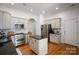 Beautiful kitchen features an island, stainless appliances, custom cabinets, and hardwood floors at 4008 Saint Andrews Ct, Cramerton, NC 28032