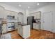 Bright kitchen with a center island, stainless steel appliances, and custom cabinetry at 4008 Saint Andrews Ct, Cramerton, NC 28032