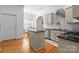 Kitchen with stainless steel dishwasher, tile backsplash, and hardwood floors, leading into breakfast nook at 4008 Saint Andrews Ct, Cramerton, NC 28032