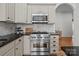 Close-up of range with stainless steel appliances, dark countertops, and custom cabinetry at 4008 Saint Andrews Ct, Cramerton, NC 28032