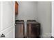 Modern laundry room equipped with a side-by-side washer and dryer set and upper cabinet at 4008 Saint Andrews Ct, Cramerton, NC 28032