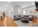 Spacious living room with hardwood floors, a sectional sofa, and an open floor plan for seamless entertaining at 4008 Saint Andrews Ct, Cramerton, NC 28032