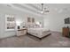 Bright main bedroom with a tray ceiling, carpet floors, and ample natural light at 4008 Saint Andrews Ct, Cramerton, NC 28032